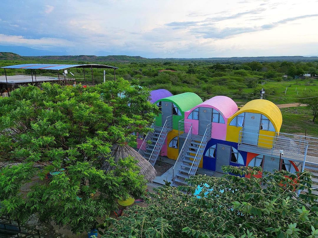 The rooms are constructed from concrete sewer pipes painted in bright colours.